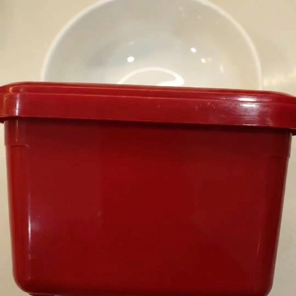 Ingredientes para la salsa picante siendo mezclados en un bol blanco.