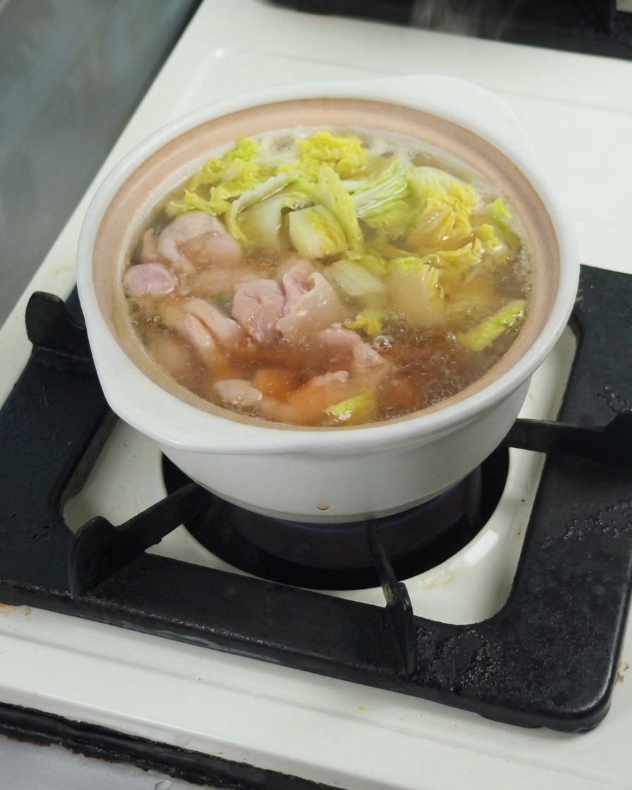 Vertiendo salsa de soja en el caldo para sazonar la sopa.