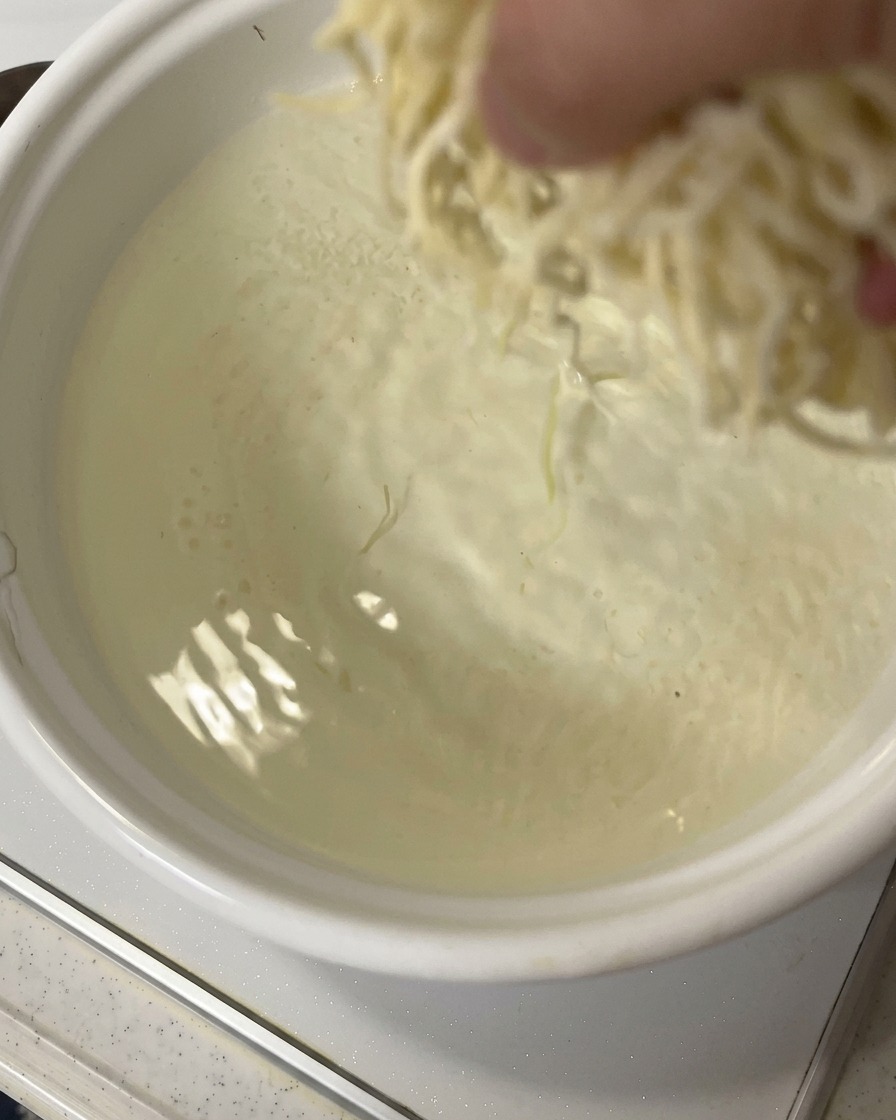 Fideos de ramen frescos cayendo en agua hirviendo.
