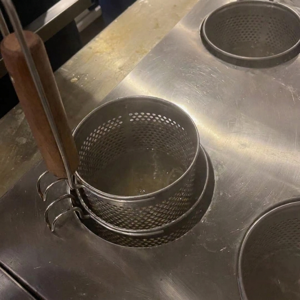 Fideos removiéndose en agua hirviendo con palillos de madera.