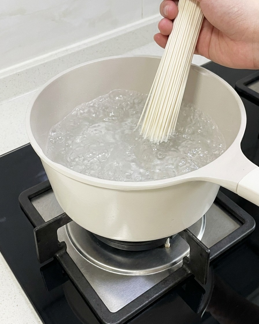 Fideos de ramen hirviendo en una olla con agua.