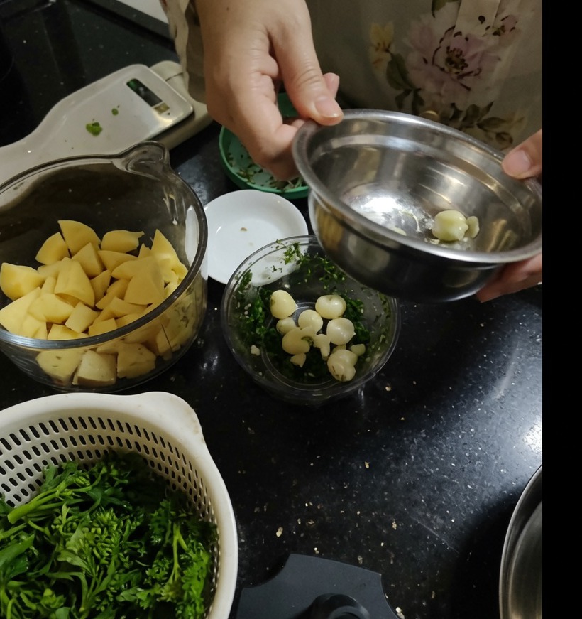 Dientes de ajo pelados dentro de un recipiente de procesador de alimentos manual.