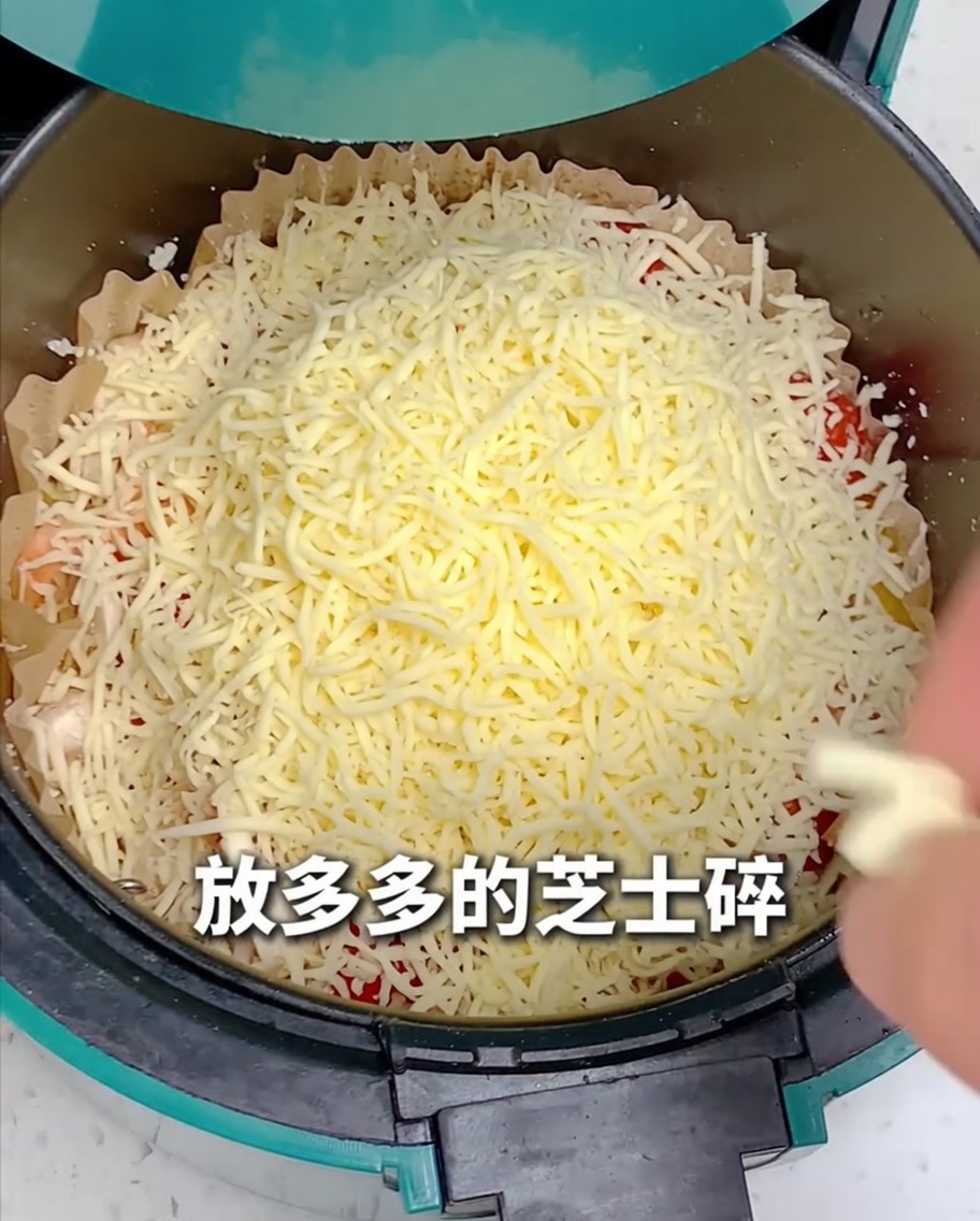 Queso rallado siendo esparcido sobre toda la pizza en la freidora.