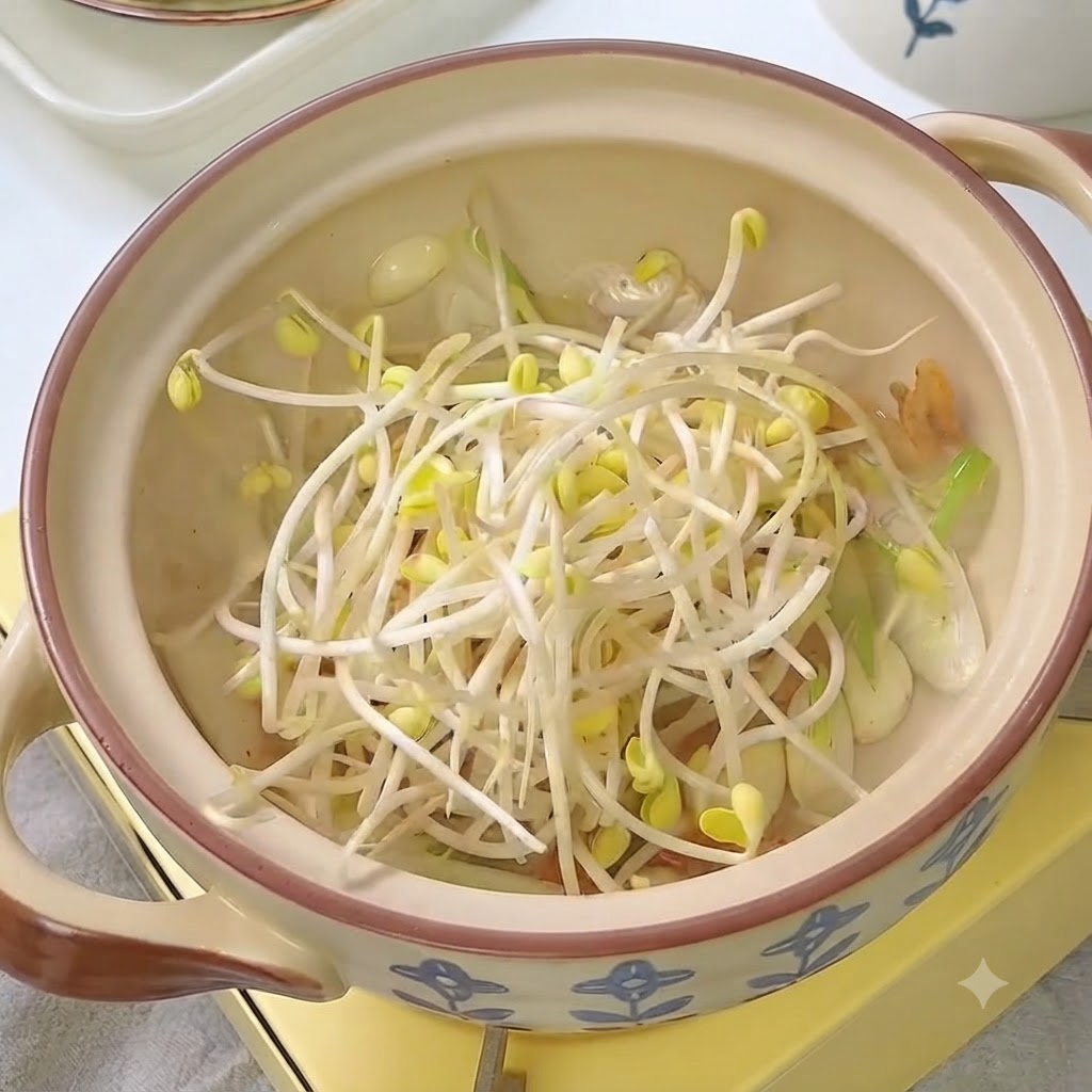 Brotes de soja frescos colocados en la olla con kimchi y aromáticos.
