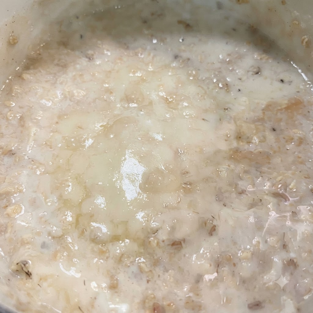 Leche y una rebanada de queso bajo en grasa derritiéndose juntas en la sartén para formar una salsa cremosa.