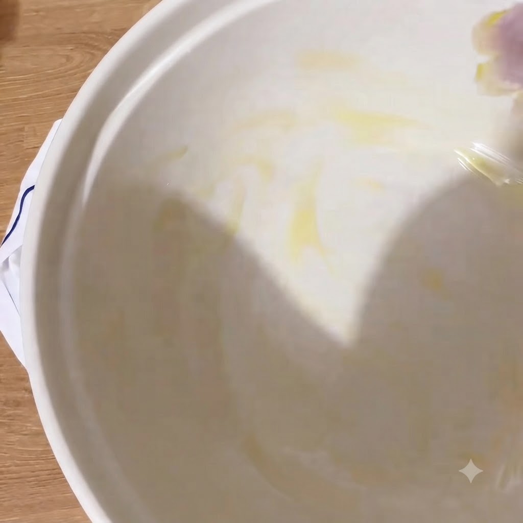 El interior de un bol blanco brillando con una capa de aceite de oliva virgen extra.