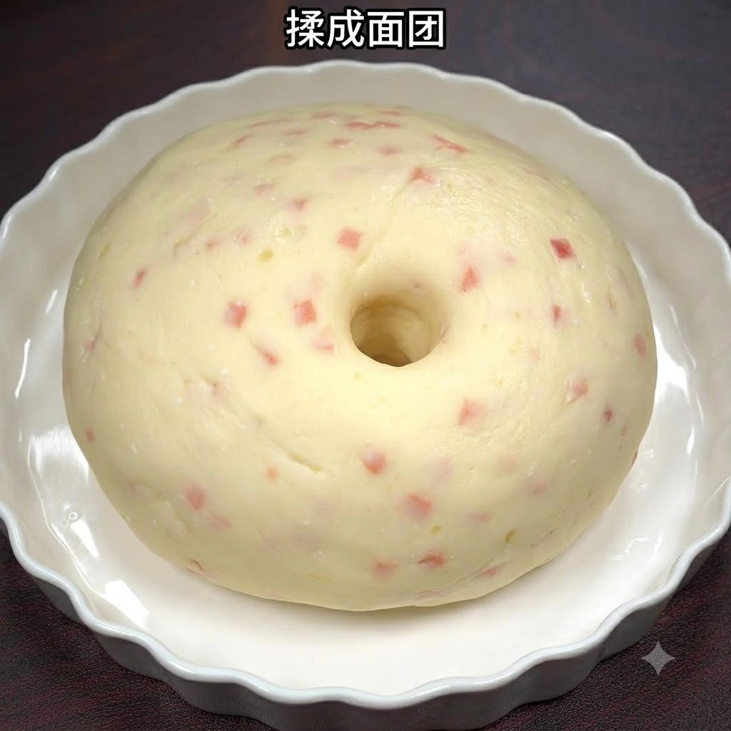 Masa suave de patata y jamón moldeada en forma de bola dentro de un plato de cerámica blanco.