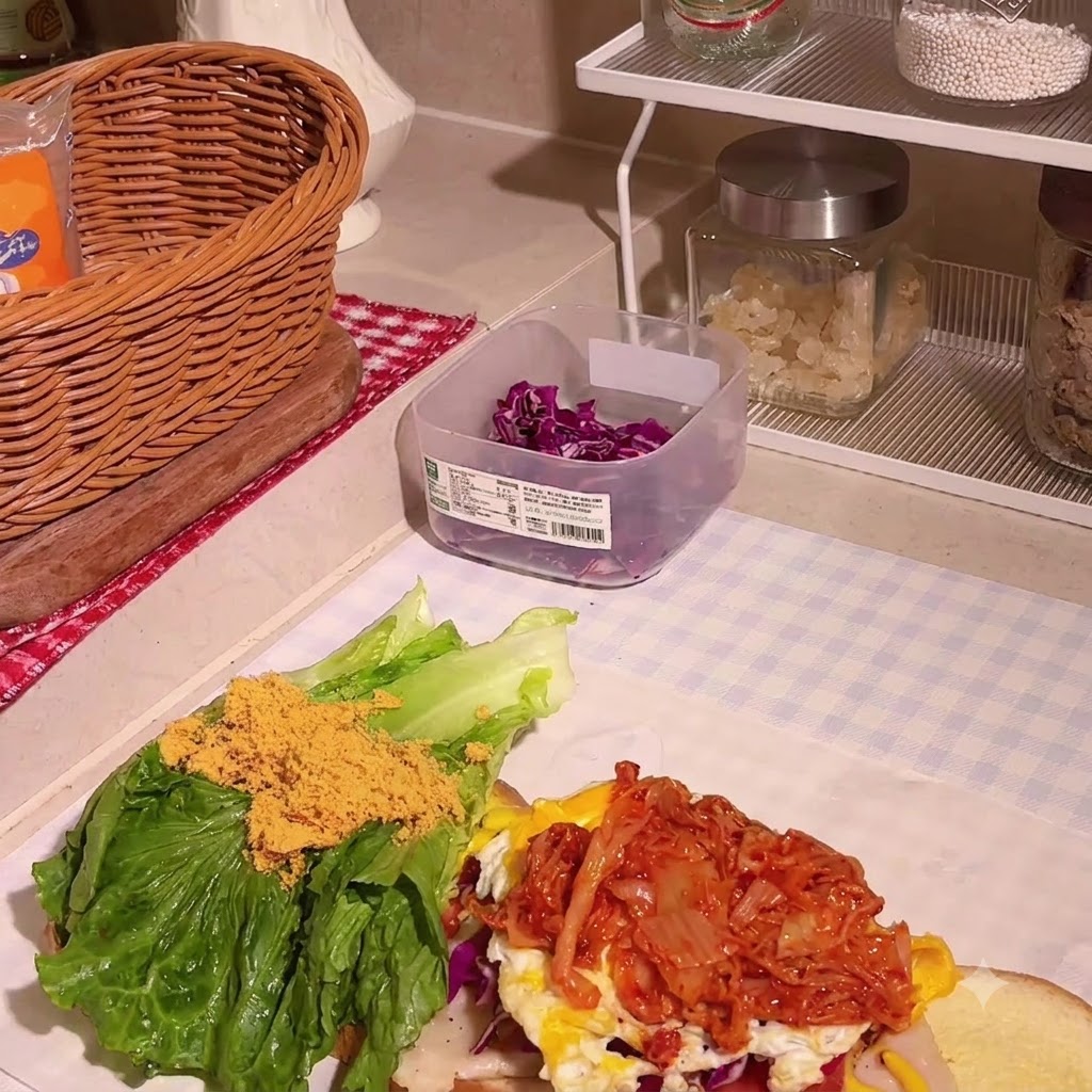 Carne de pollo desmenuzada siendo espolvoreada sobre la lechuga y otros rellenos.