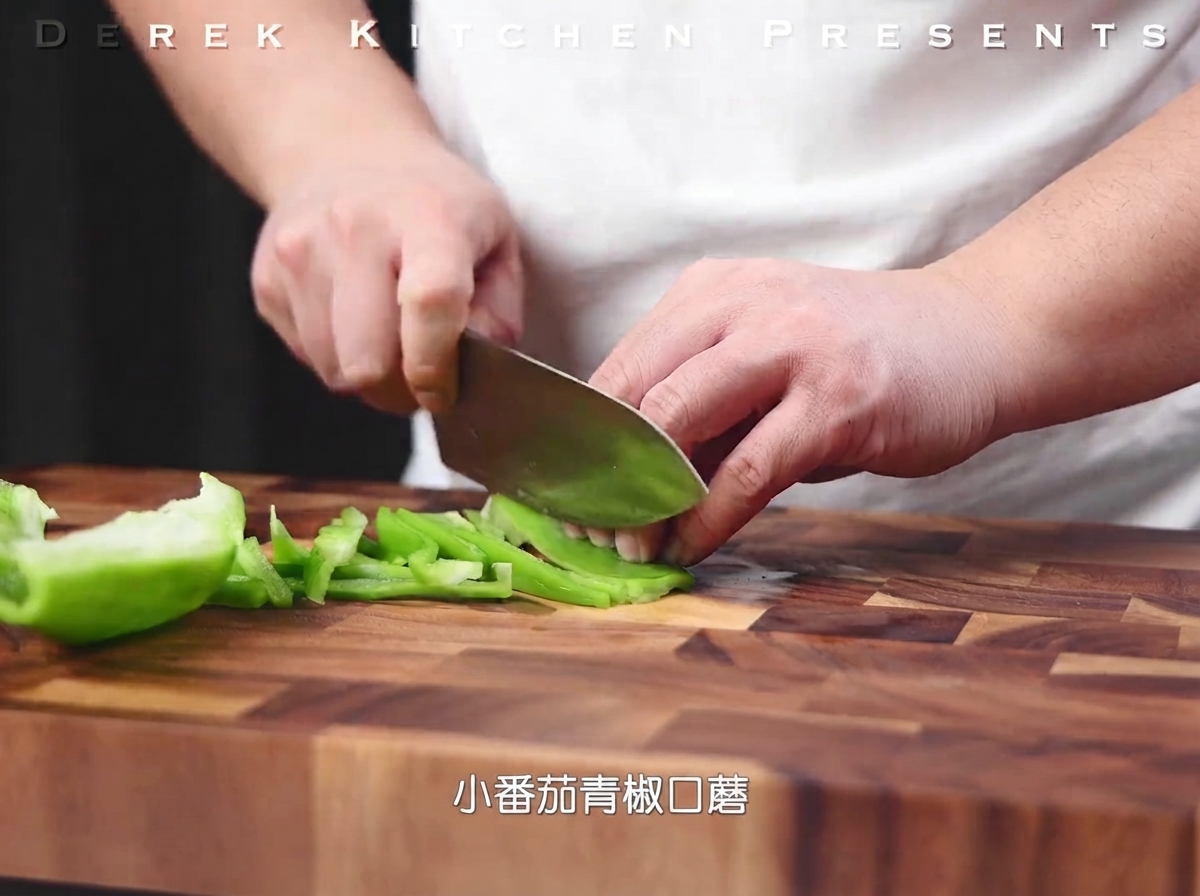 Pimientos verdes siendo cortados en tiras finas sobre una tabla de cortar de madera.