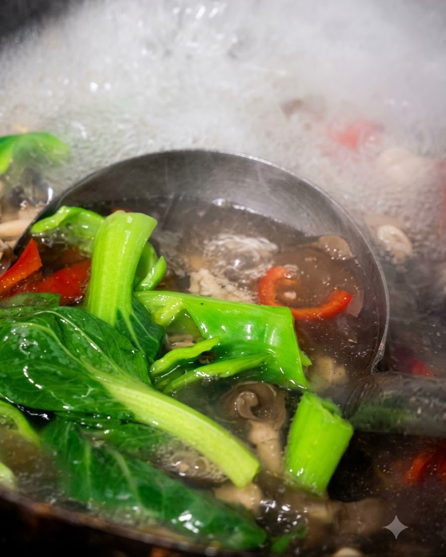 Un cucharón sacando pak choi, pimientos y hongos cocidos del agua hirviendo.